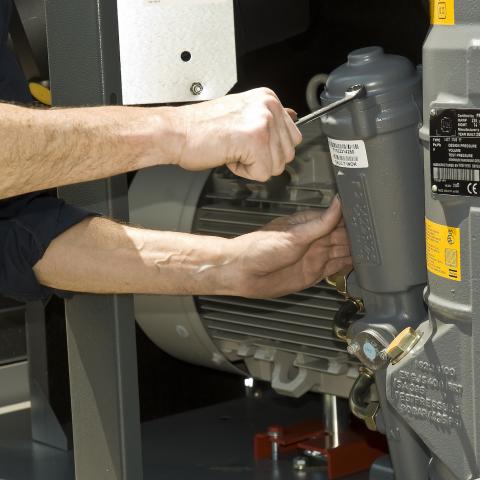 Dynamic Fluid Power technician working on an Atlas Copco compressor