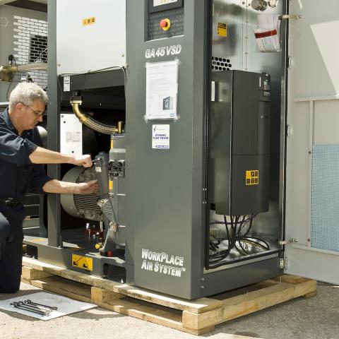 Dynamic Fluid Power technician working on an Atlas Copco compressor